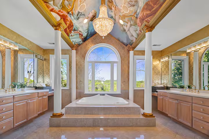 The Private Suite spa bath beneath hand-painted ceilings